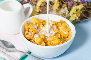 Corn flakes in a bowl with fresh milk for eating in the morning,breakfast or meal