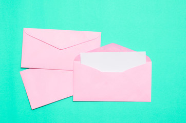 Pink envelope with blank white card on color background