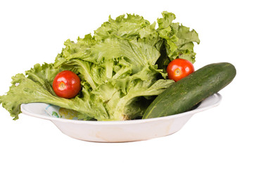 Salad, tomato and cucumber on a plate.