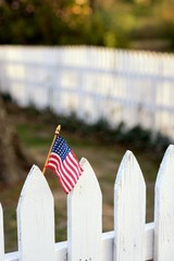 American Flag on white picket fence