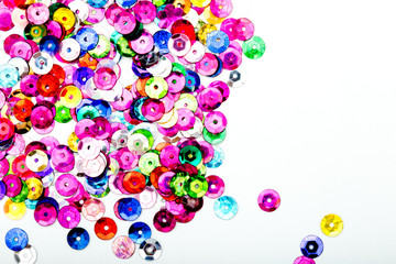 Abstract Background - close up of multi colored sequins on white background