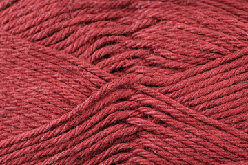 A super close up image of maroon yarn