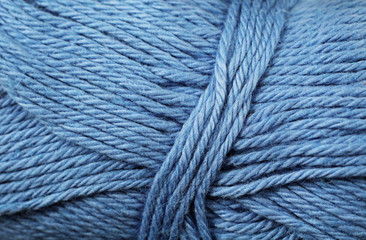 A super close up image of blue yarn