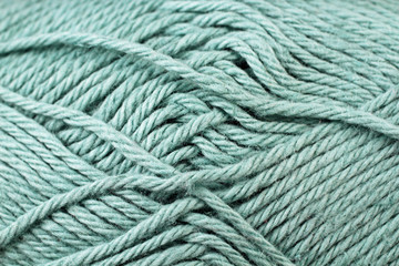 A super close up image of pale blue yarn