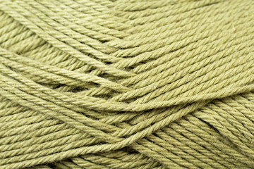 A super close up image of split pea green yarn