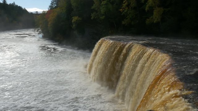 Gimbal-mounted camera with smooth motion over fence of Upper Tahquamenon Falls in Autumn, in the Upper Peninsula of Michigan.