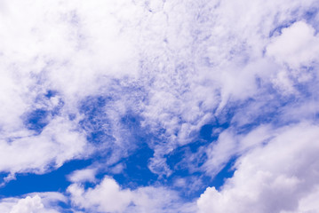 Blue sky background with tiny clouds