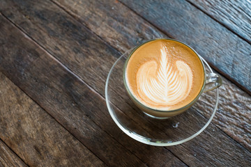 Latte Art Coffee on vintage wooden table