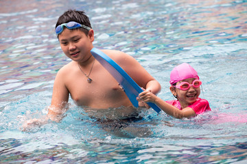 Two happy kids in a swimming pool