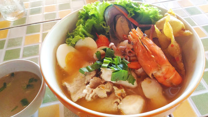 Tom Yam Koong soup with noodles sea food