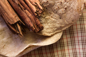 cinnamon sticks on dried tortilla in rustic style