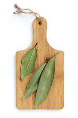 Dried Bay leaves on Wooden Chopping Board Isolated