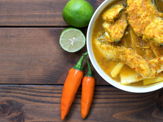 Yellow curry with snapper fish and coconut shoots, a bowl of thai food.