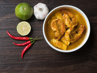 Yellow curry with shrimp and coconut shoots, a bowl of thai food.