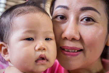 mother with her baby daugther asian