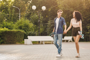 Fototapeta premium Teenagers with skateboards at park