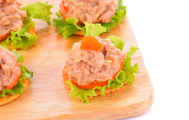 Tuna salad on a biscuit on a white background.