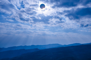 Scientific natural phenomenon. Total solar eclipse with diamond ring effect glowing on sky.