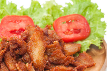 fried pork with garlic on plate isolated on white background