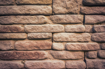 Weathered texture of stained old brown brick wall background.