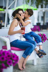Fototapeta na wymiar Son kisses mother at the resort outdoors