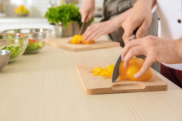 Chef giving cooking classes in kitchen