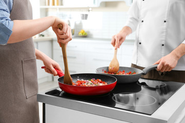 Chef giving cooking classes in kitchen