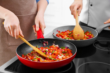 Chef giving cooking classes in kitchen
