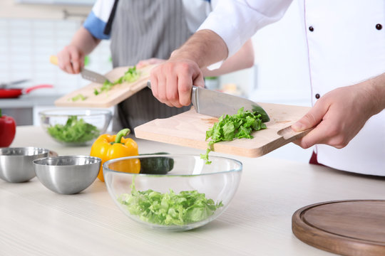 Chef giving cooking classes in kitchen