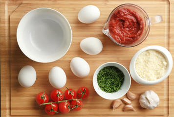 Ingredients for eggs in purgatory on wooden background