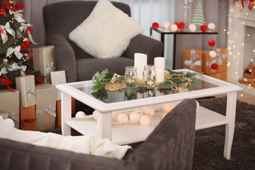 Table with beautiful Christmas decorations in living room