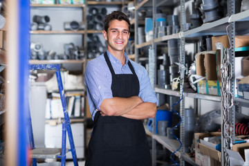 Portrait of professional male in uniform on his workplace in building store.