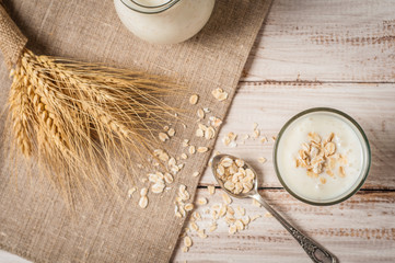 Fresh dairy products and wheat on rustic wooden background. Organic farming dairy concept