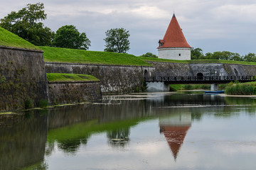 Fototapeta na wymiar Castle tower reflected in the river, Saaremaa