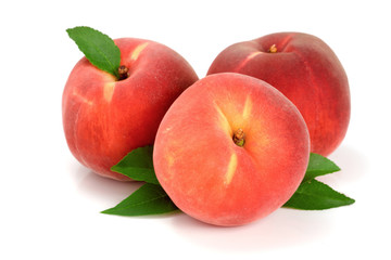 Three peaches with green leaf isolated on white background