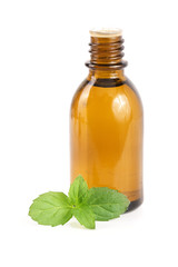 bottle of peppermint oil and fresh mint isolated on white background