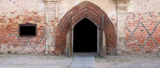 Open doors to the old ruined village church