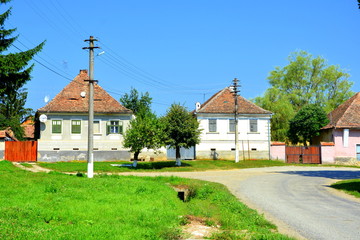 Fototapeta premium Typical rural landscape and peasant houses in Bruiu - Braller, a commune in Sibiu County, Transylvania, Romania. The settlement was founded by the Saxon colonists in the middle of the 12th century
