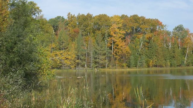 Panning view of Thumb Lake in Hudson Township, Charlevoix County, Michigan in autumn.