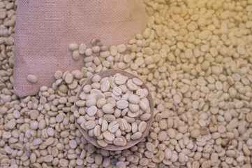 Coffee beans in bamboo tray  on brown wooden background