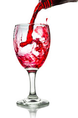 Red wine pouring on a glass isolated on white background. Clipping path