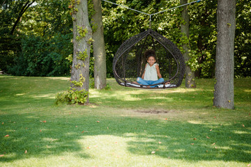 Fototapeta premium kid swinging on swing in park