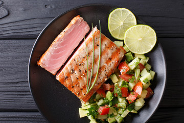 Mexican tuna steak with avocado cucumber salsa closeup. horizontal view from above