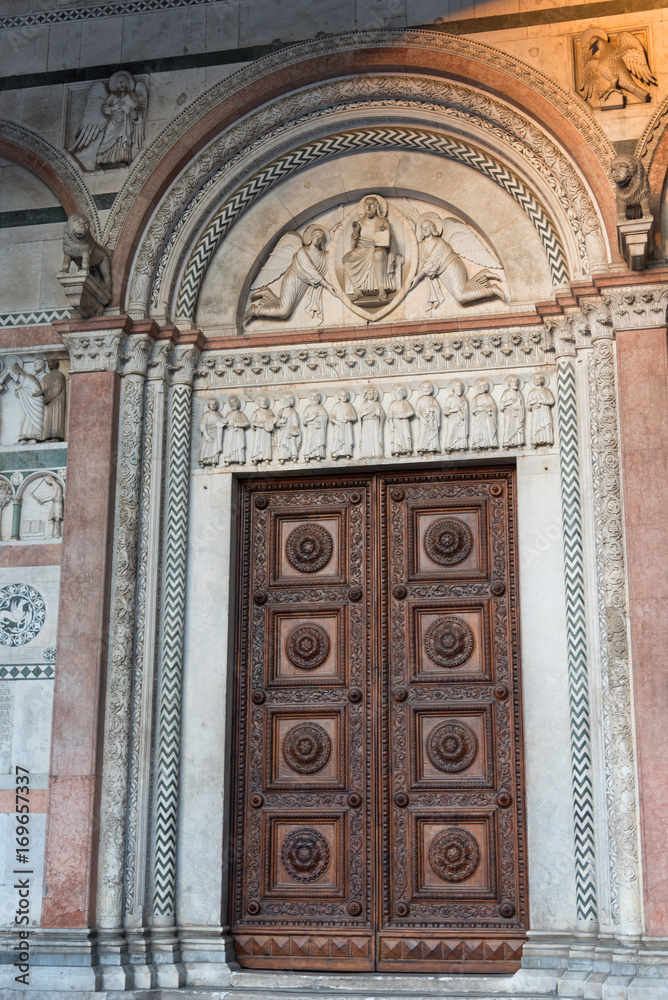 Wall mural details of the romanesque facade and bell tower of st. martin cathedral in lucca, tuscany.