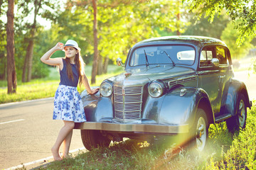Young girl with old car