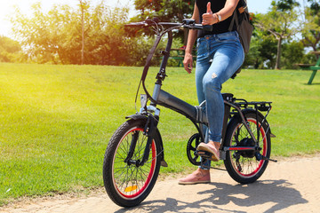 Fototapeta premium woman on electric bicycle in the park