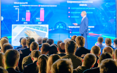 Audience listens to the lecturer at the conference hall