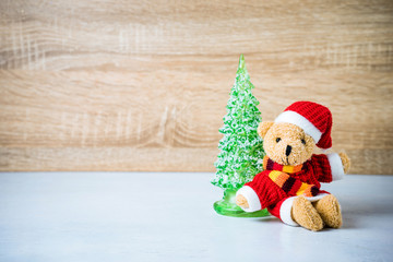 Christmas decoration Teddy Bear and christmas tree on wooden background