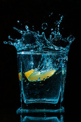 Lemon splashes in a water glass