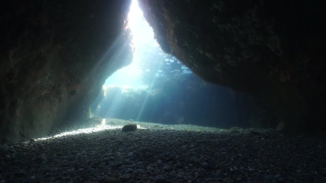 Underwater cave exit with sun beam, Mediterranean sea, natural scene, Vermilion coast, Pyrenees Orientales, Roussillon, France, 60fps
